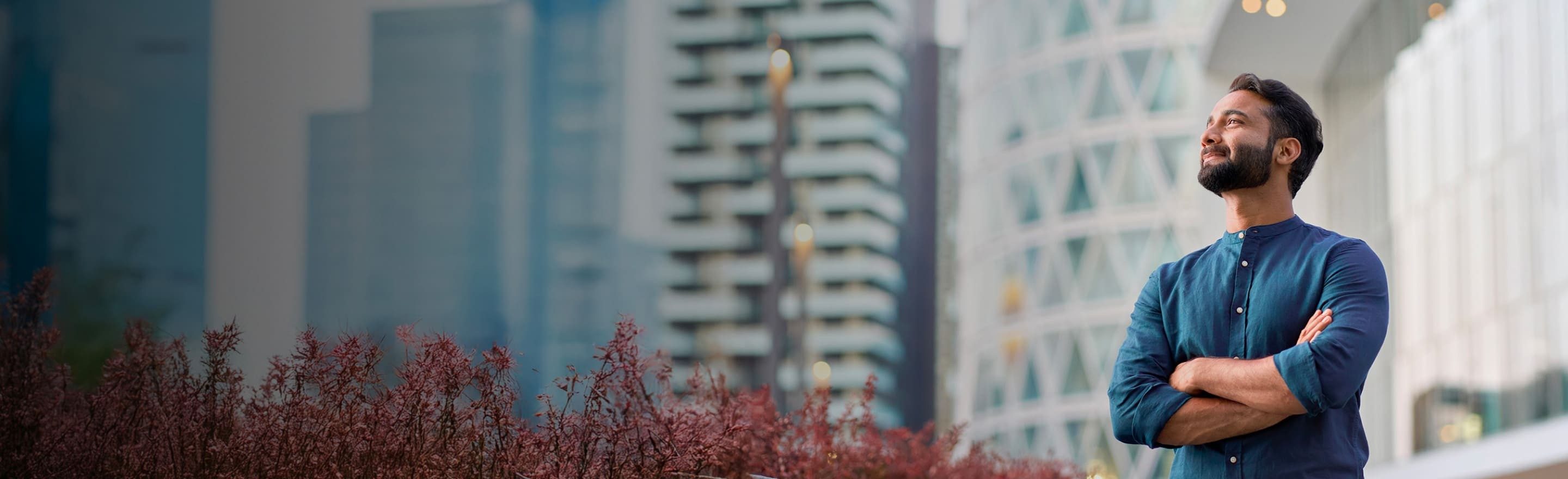 A smiling man looks confidently upwards in a modern setting
